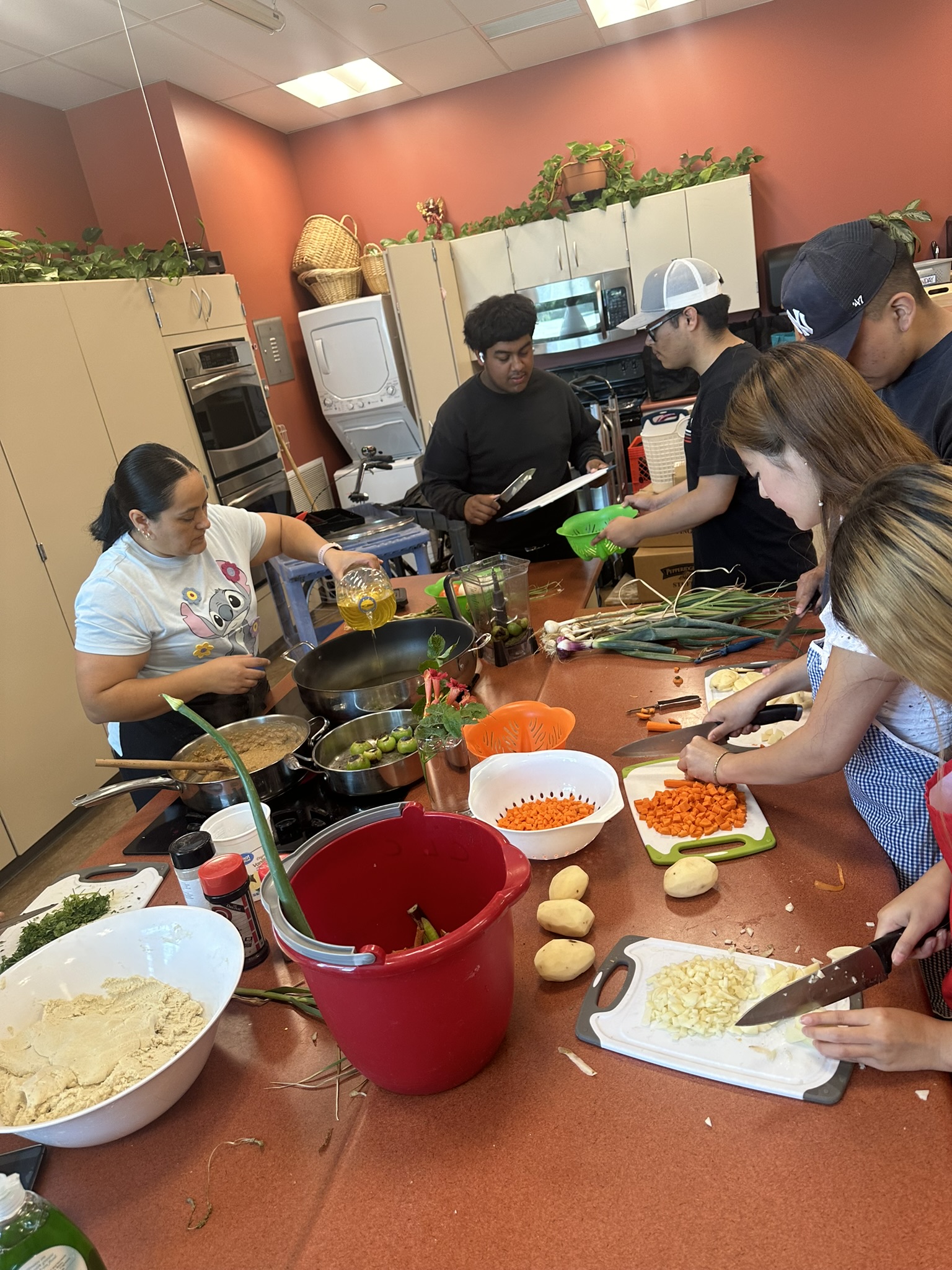 Students preparing food around a table